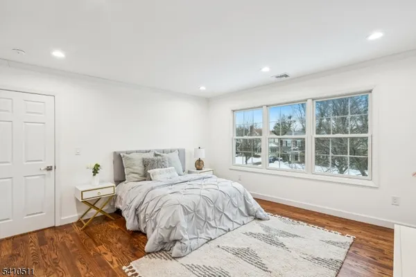 a bedroom with a large bed and a window