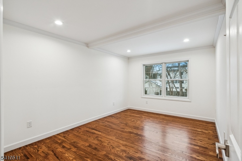 161 Myrtle Avenue Millburn, NJ 07041 - Photo 20 of 43 an empty room with wooden floor and window