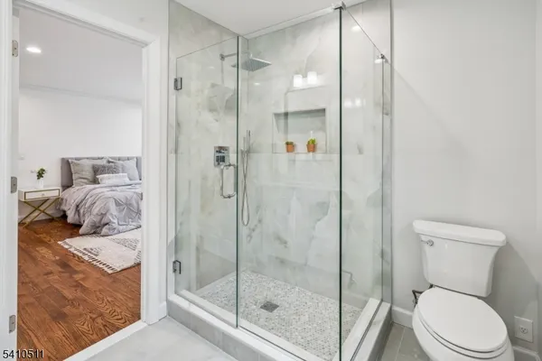 a bathroom with a shower and toilet