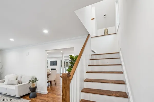 a view of entryway with furniture and wooden floor
