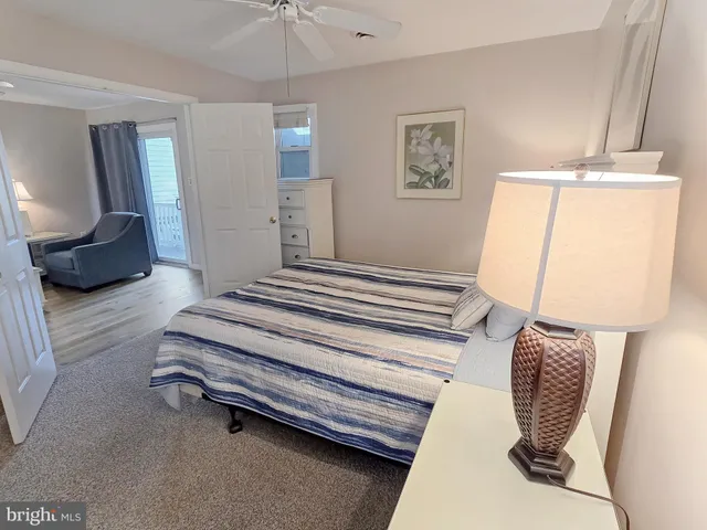 a bedroom with a bed and a mirror