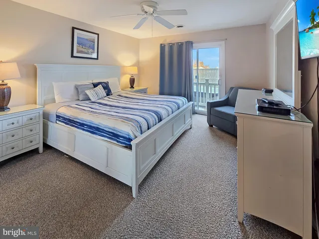 a spacious bedroom with a bed and a chandelier