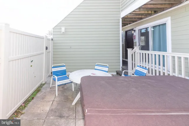 a balcony with table and chairs