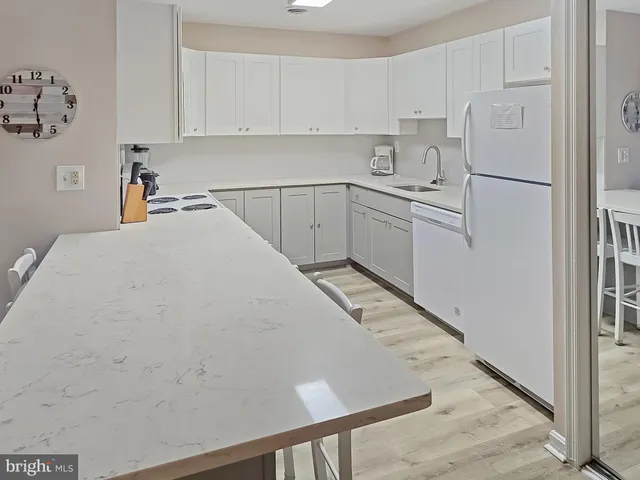 a utility room with cabinets washer and dryer