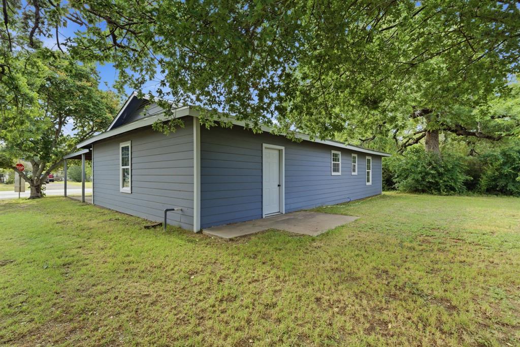 203 North Kickapoo Street Lipan, TX 76462 - Photo 28 of 28 a backyard of a house with lots of green space