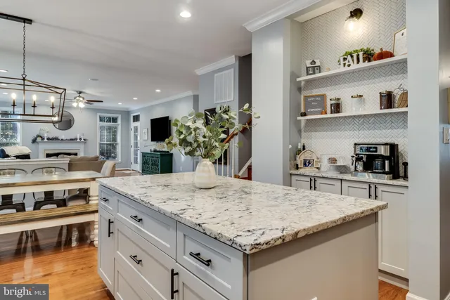 a kitchen with granite countertop a stove and cabinets