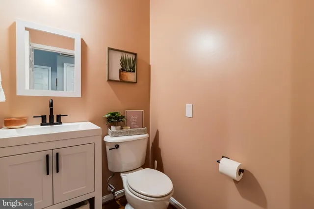 a bathroom with a toilet a sink and mirror