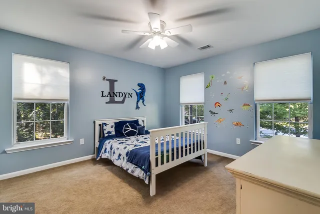 a bedroom with a bed next to a large window
