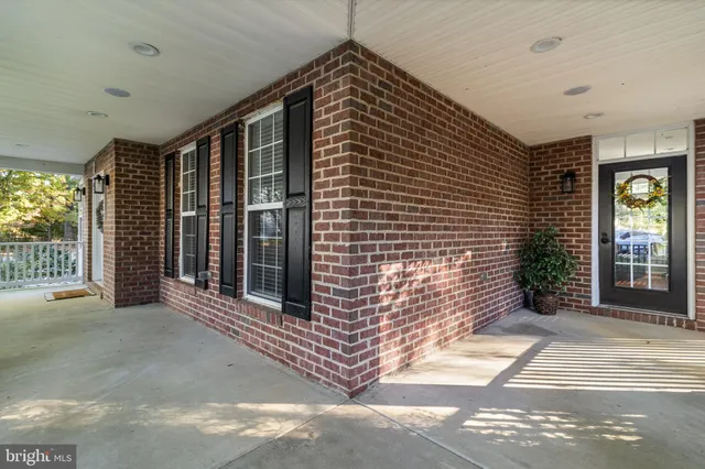 a view of a brick house with entryway and windows