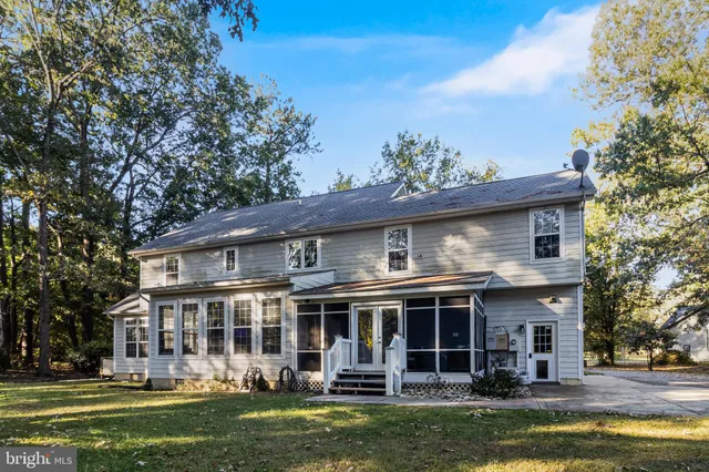 a front view of a building with a garden and plants