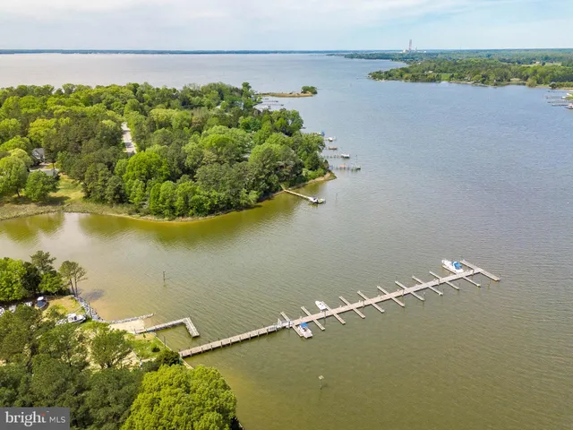 an aerial view of a houses with a lake view