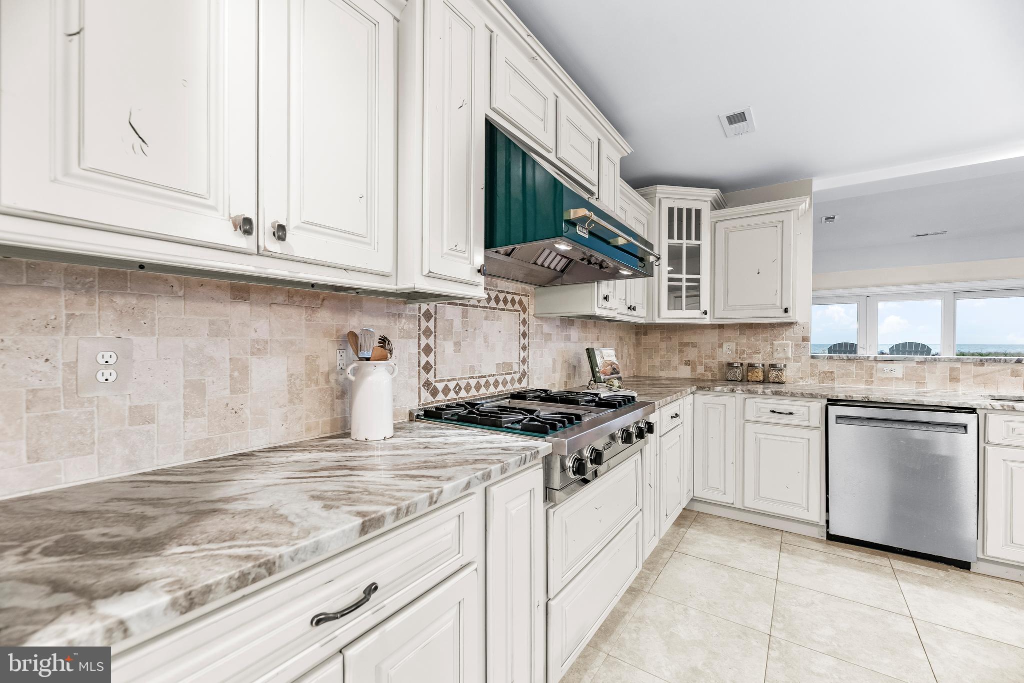 3095 Calvert Boulevard Lusby, MD 20657 - Photo 11 of 105 a kitchen with stainless steel appliances granite countertop a stove a sink and a white cabinets