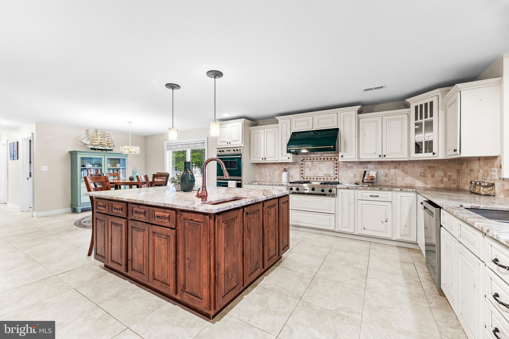 3095 Calvert Boulevard Lusby, MD 20657 - Photo 14 of 105 a kitchen with stainless steel appliances granite countertop a sink and cabinets