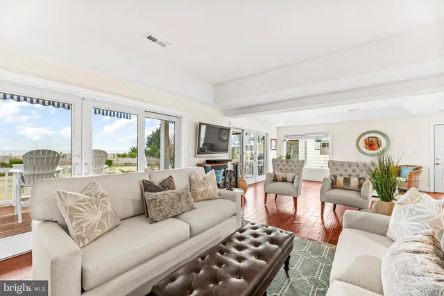 a utility room with stainless steel appliances granite countertop a sink a washer and dryer with wooden cabinets