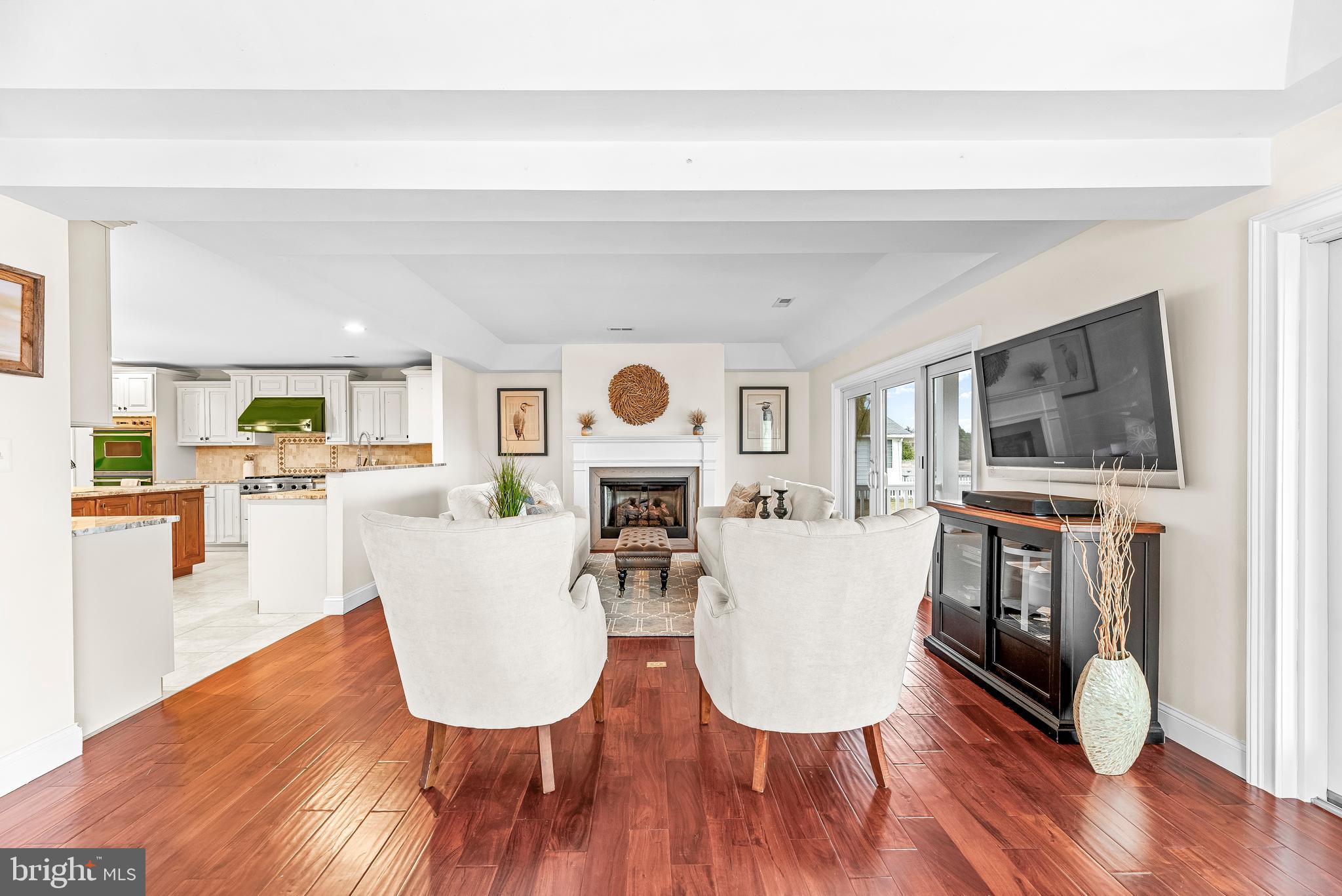3095 Calvert Boulevard Lusby, MD 20657 - Photo 25 of 105 a living room with furniture a fireplace and a flat screen tv