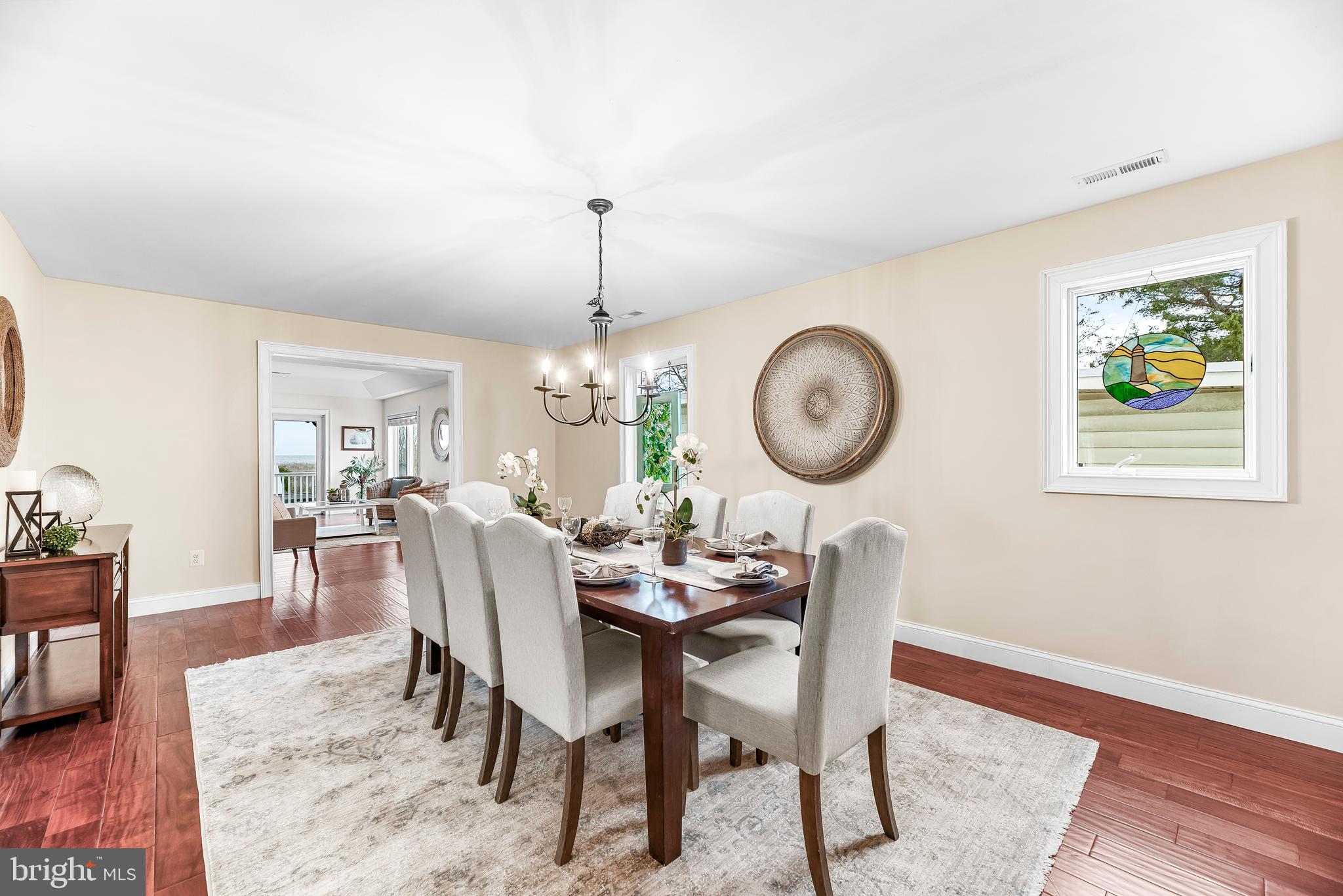 3095 Calvert Boulevard Lusby, MD 20657 - Photo 29 of 105 a view of a dining room with furniture wooden floor and a rug