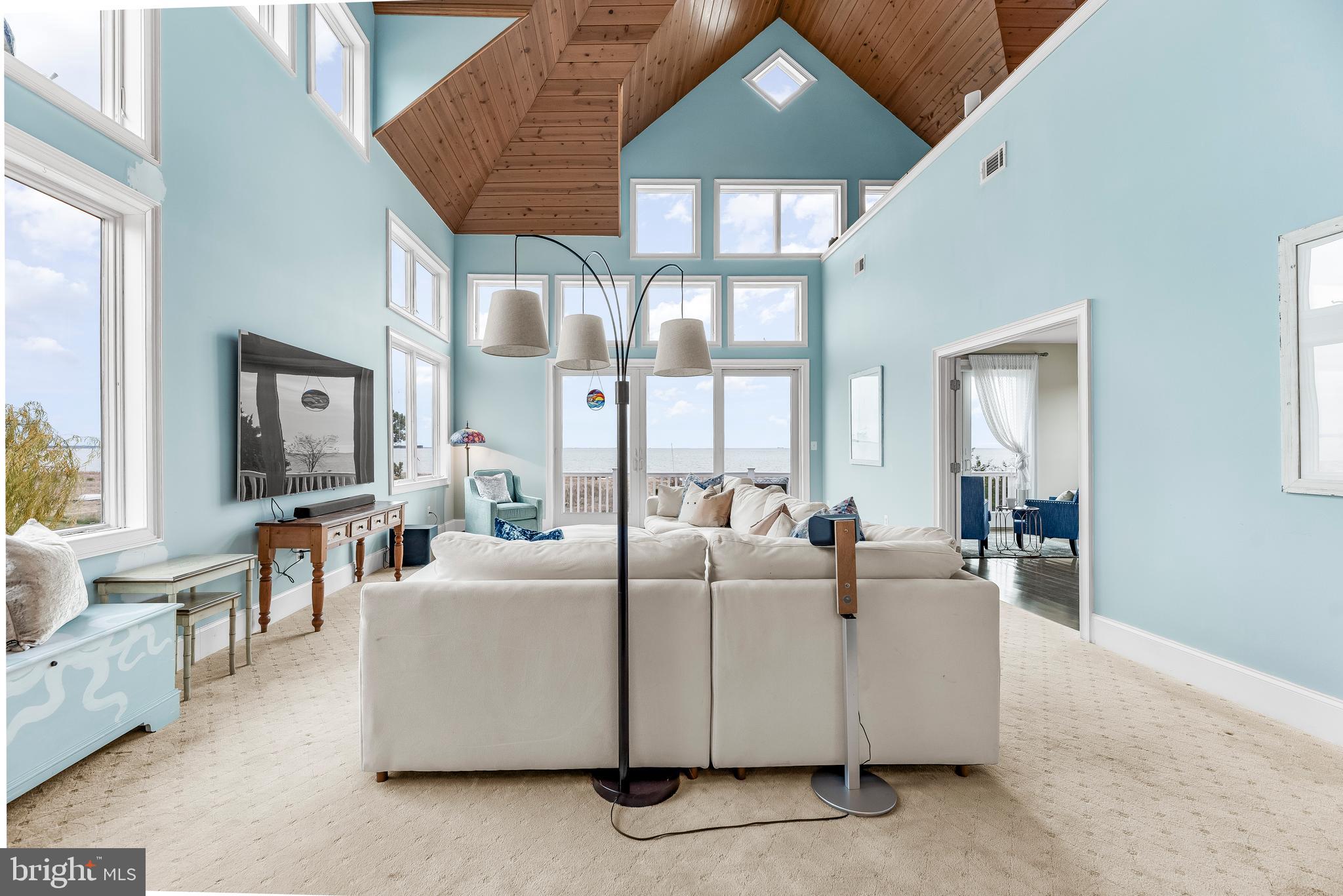 3095 Calvert Boulevard Lusby, MD 20657 - Photo 35 of 105 a living room with furniture a chandelier and a large window