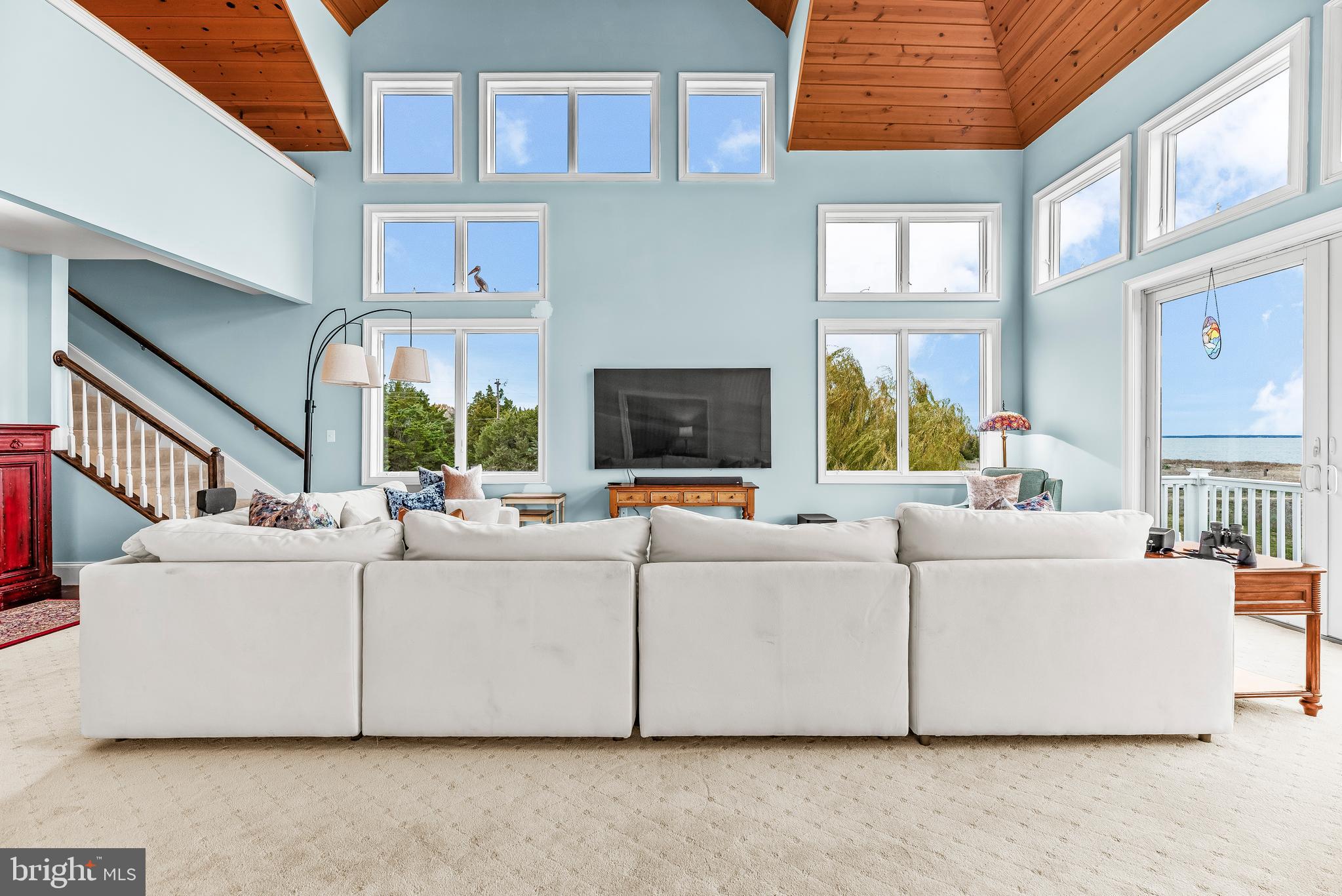 3095 Calvert Boulevard Lusby, MD 20657 - Photo 50 of 105 a living room with furniture a fireplace and a large window