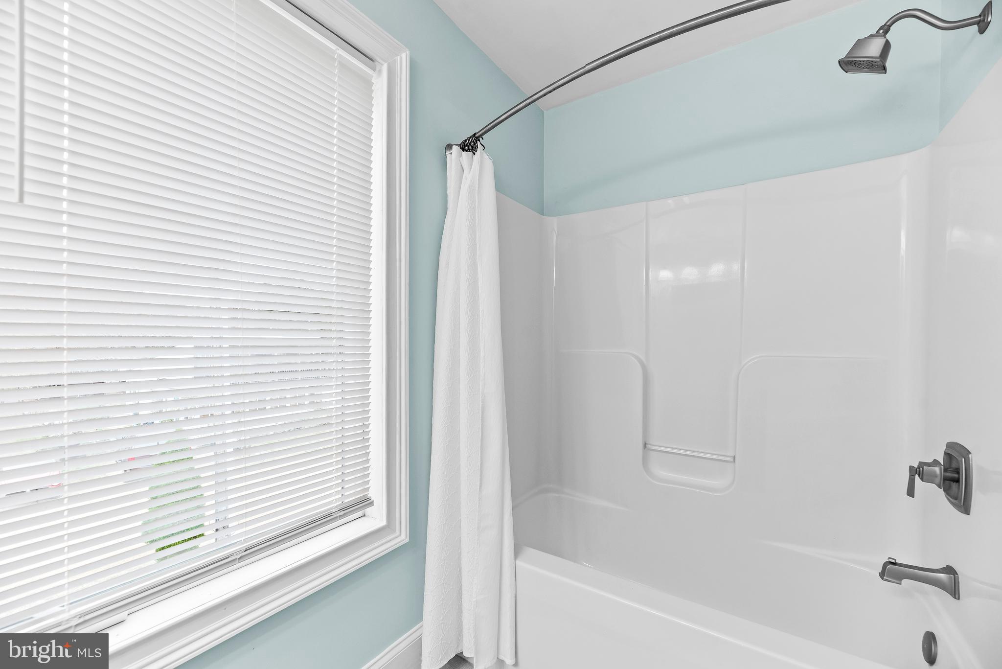 3095 Calvert Boulevard Lusby, MD 20657 - Photo 55 of 105 a bathroom with a bathtub and a shower