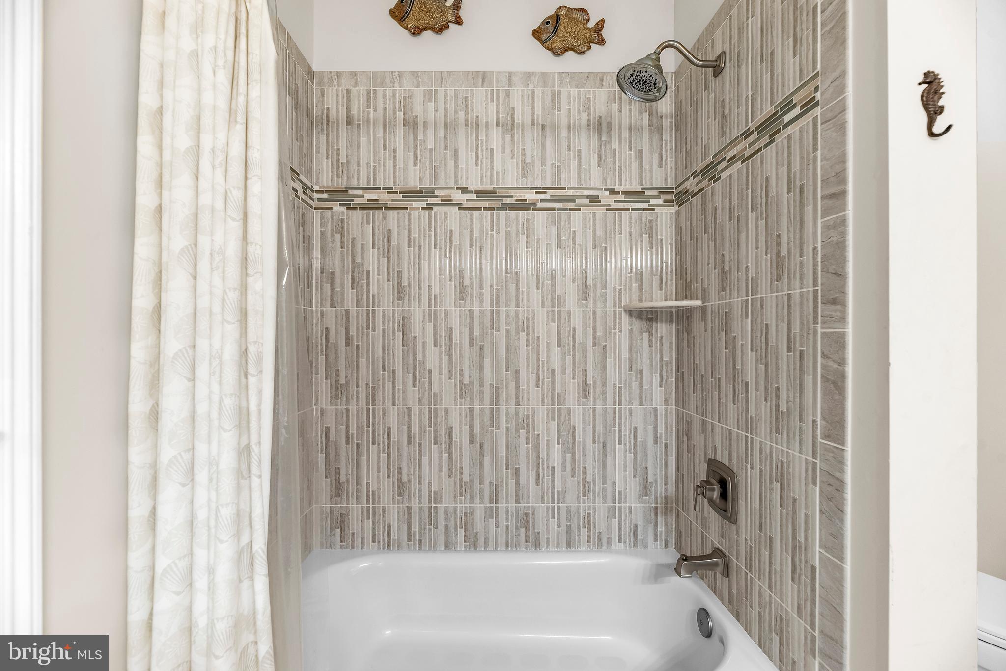 3095 Calvert Boulevard Lusby, MD 20657 - Photo 57 of 105 a bathroom with a shower and a bath tub