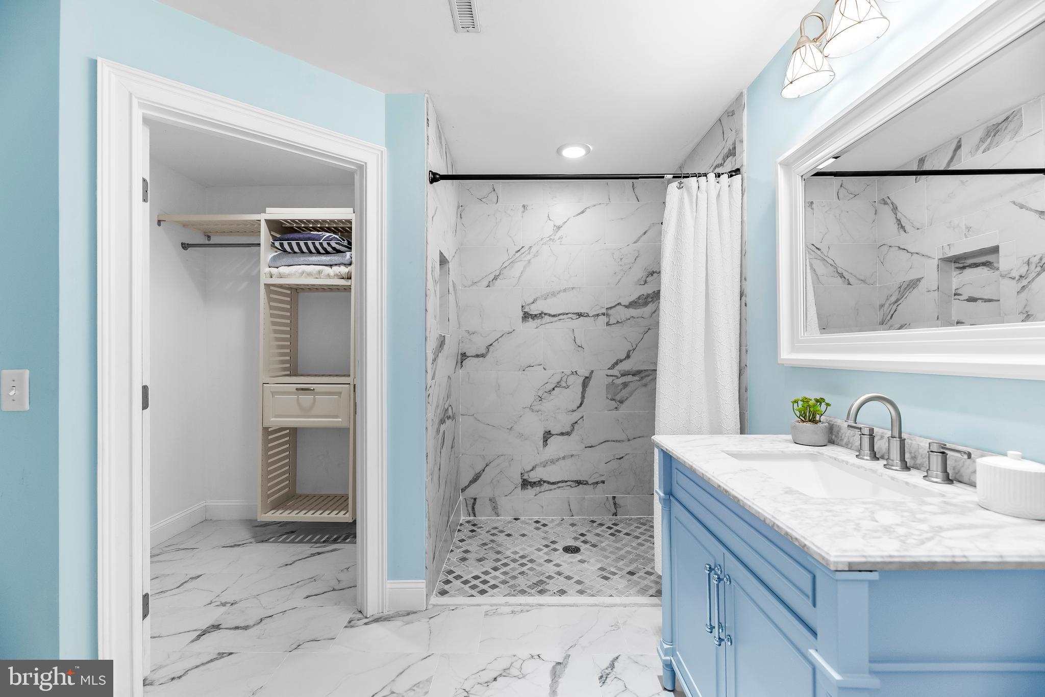 3095 Calvert Boulevard Lusby, MD 20657 - Photo 68 of 105 a bathroom with a granite countertop sink a mirror and shower