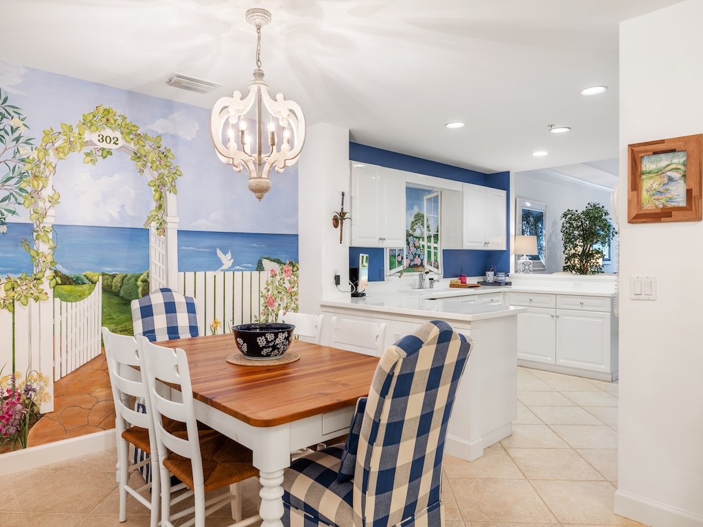 940 Turtle Cove Lane, Unit 302 Vero Beach, FL 32963 - Photo 12 of 30 a view of a dining room with furniture and chandelier
