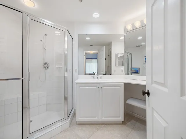 a bathroom with a shower a sink and a mirror
