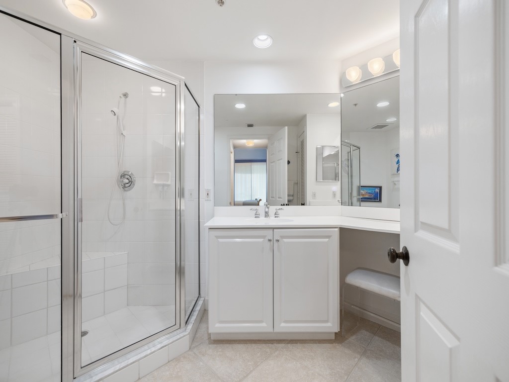 940 Turtle Cove Lane, Unit 302 Vero Beach, FL 32963 - Photo 16 of 30 a bathroom with a shower a sink and a mirror