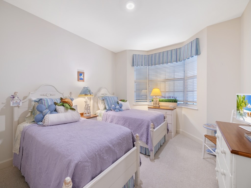 940 Turtle Cove Lane, Unit 302 Vero Beach, FL 32963 - Photo 17 of 30 a bedroom with two beds and painting on the wall