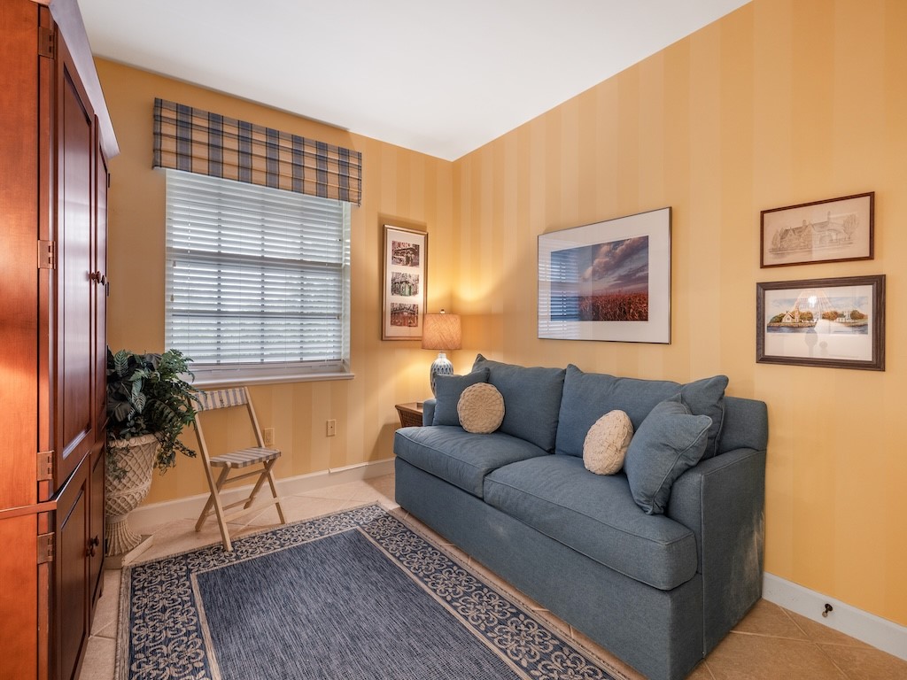 940 Turtle Cove Lane, Unit 302 Vero Beach, FL 32963 - Photo 21 of 30 a living room with furniture and a window