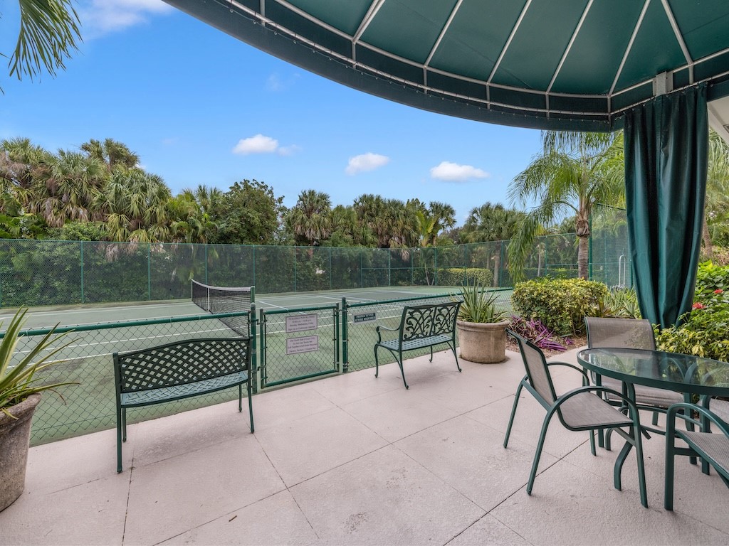 940 Turtle Cove Lane, Unit 302 Vero Beach, FL 32963 - Photo 26 of 30 a view of a chairs and table in patio