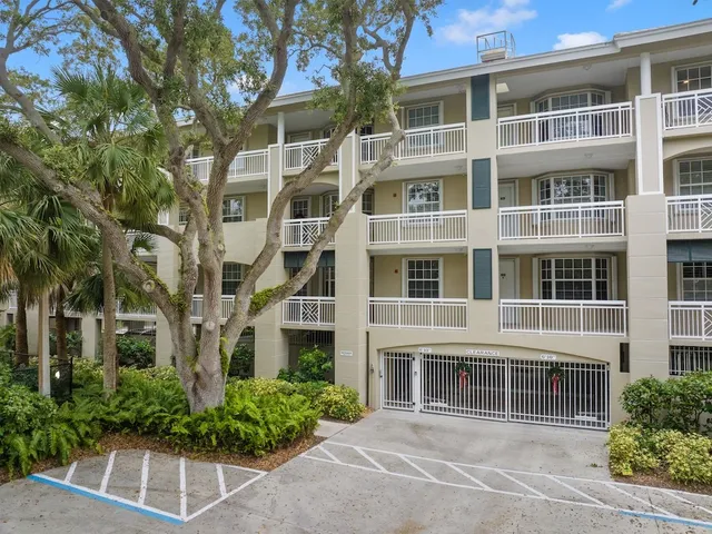 a view of a house with pool and chairs