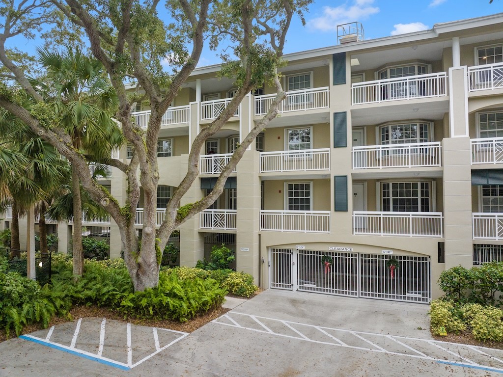 940 Turtle Cove Lane, Unit 302 Vero Beach, FL 32963 - Photo 27 of 30 a front view of a building with a garden