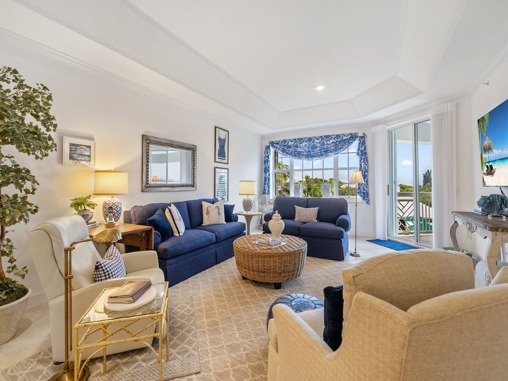 940 Turtle Cove Lane, Unit 302 Vero Beach, FL 32963 - Photo 5 of 30 a living room with furniture and a large window
