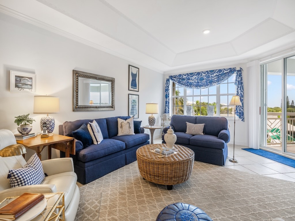 940 Turtle Cove Lane, Unit 302 Vero Beach, FL 32963 - Photo 7 of 30 a living room with furniture and a large window
