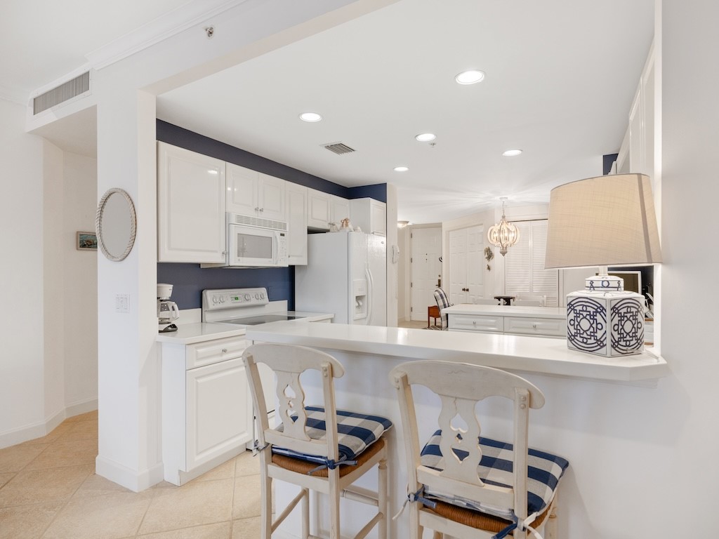 940 Turtle Cove Lane, Unit 302 Vero Beach, FL 32963 - Photo 10 of 30 a kitchen with a sink appliances and cabinets