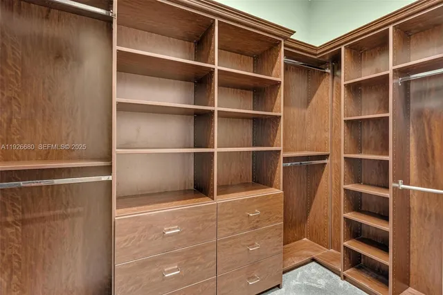 a living room with furniture a flat screen tv and a chandelier