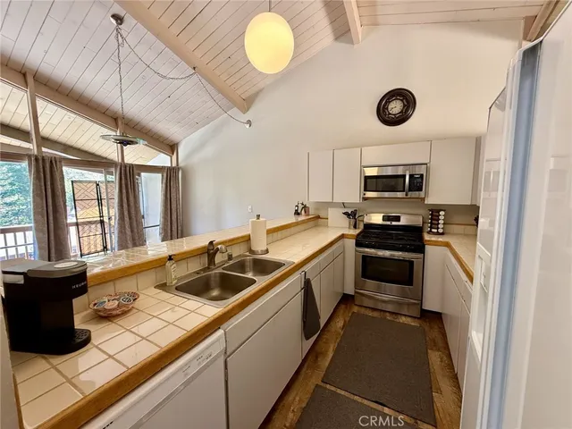a kitchen that has a sink and a stove top oven