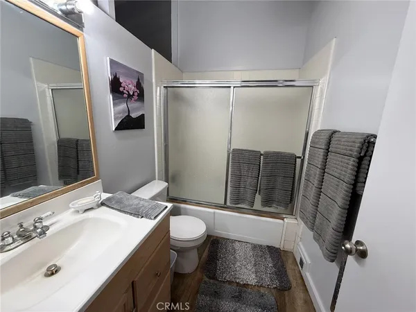 a bathroom with a sink mirror vanity and toilet