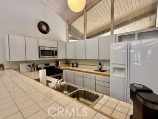 a kitchen with a sink appliances and cabinets