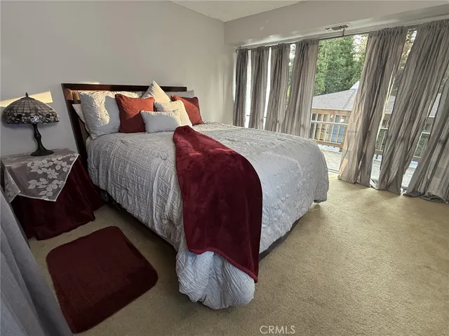 a bed sitting in a bedroom next to a window