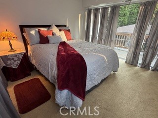 872 Sierra Vista Drive Twin Peaks, CA 92391 - Photo 23 of 37 a bed sitting in a bedroom next to a window