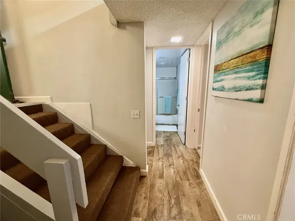 a view of hallway with wooden floor