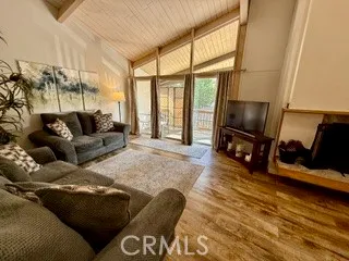 a living room with furniture a large window and a flat screen tv