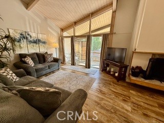 872 Sierra Vista Drive Twin Peaks, CA 92391 - Photo 10 of 37 a living room with furniture a large window and a flat screen tv