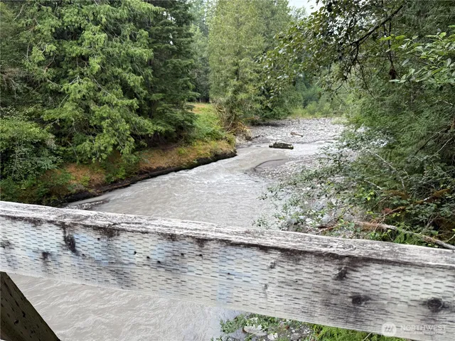 a view of a dry yard with wooden fence