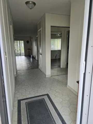 a view of a hallway to rooms