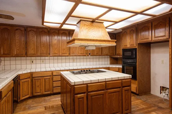 a kitchen with a sink stove and cabinets