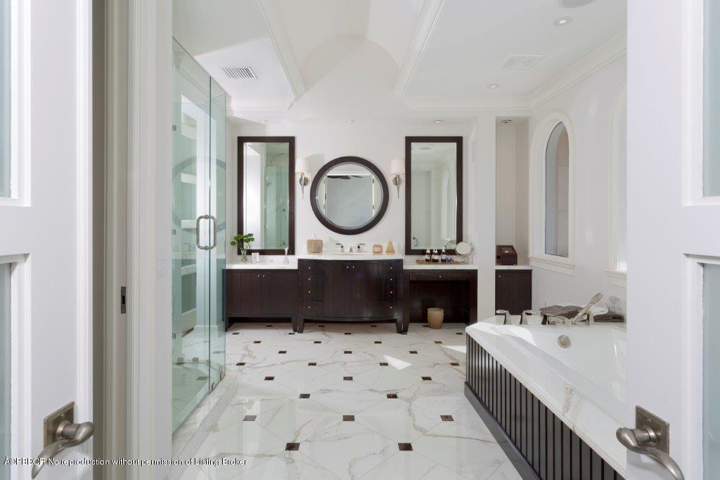 95 Curlew Road Manalapan, FL 33462 - Photo 17 of 36 a bathroom with a sink a toilet and a mirror