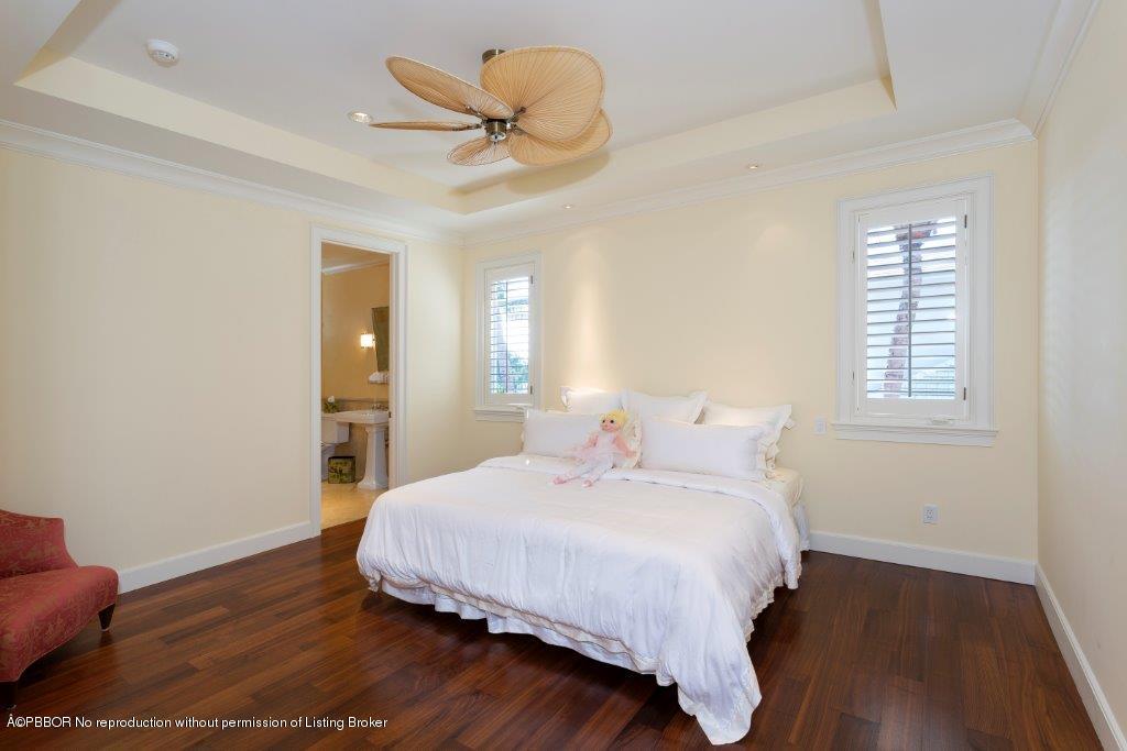 95 Curlew Road Manalapan, FL 33462 - Photo 21 of 36 a bedroom with a bed and wooden floor